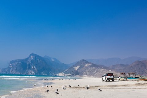 Reisebericht
                           Oman Al Fazajah Beach im Hintergrund das Jabal al Qamar Gebirge richtung Jemen